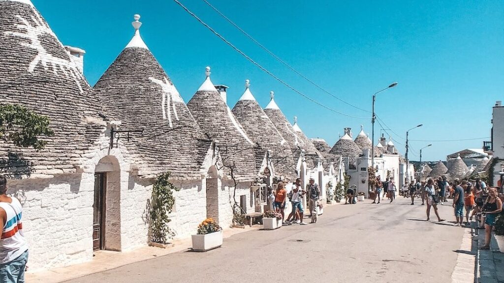 people walking on street near houses during daytime