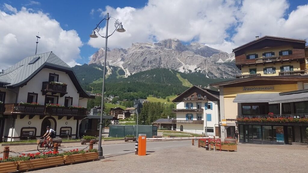 a town square with a mountain in the background